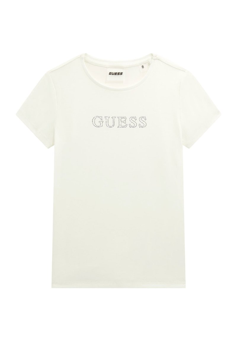T-shirt blanc à manches courtes en coton avec un col rond et un logo "GUESS" en strass. Présente une texture simple et lisse.