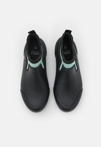 Black water shoes with a smooth texture, featuring a green accent around the collar and a slip-on design for easy wear.