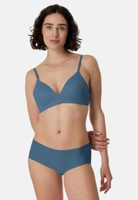 Reggiseno blu senza cuciture e slip hipster coordinati. Tessuto morbido ed elastico con una finitura liscia. Il reggiseno presenta spalline sottili regolabili e un design a V.