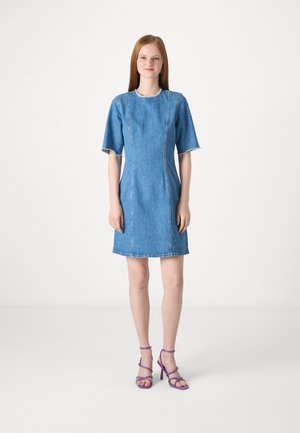 Denim dress with short sleeves, fitted bodice, and straight hem. Light blue color with contrasting stitching and frayed edges.