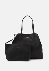 Black leather tote bag with double handles and a removable zipper pouch, featuring a textured surface and gold logo accents.