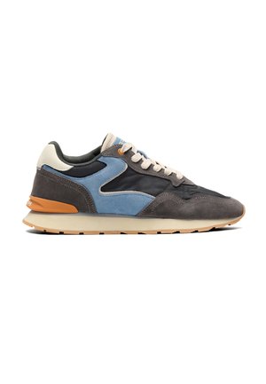 Low-top casual sneaker with suede and fabric panels in gray, blue, black, and beige, featuring cream laces and a tan rubber sole.