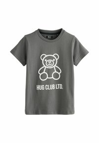 Szürke, rövid ujjú pamut póló, fehér mesebeli medve grafikával, alatta pedig a "HUG CLUB LTD." felirattal.