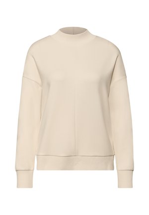 Sweat-shirt beige clair à col montant, épaules tombantes, poignets côtelés et coupe décontractée. Texture lisse.