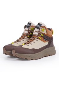 Brązowe i beżowe buty trekkingowe z teksturowaną cholewką, wyściółką wokół kostki, charakterystycznymi zielonymi i żółtymi akcentami sznurowadeł oraz wytrzymałą podeszwą.