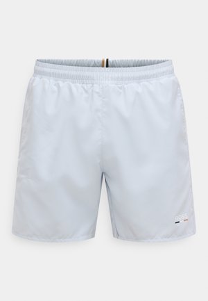 Pantaloncini da bagno azzurri in tessuto liscio, con cintura elastica, cuciture laterali e un piccolo logo nell'angolo in basso a destra.