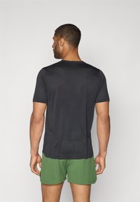 New Balance ATHLETICS GRAPHIC  - T-shirt de sport - black