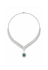 Diamond necklace featuring a V-shaped design with a central emerald-cut green gemstone pendant, silver setting, and intricate detailing.