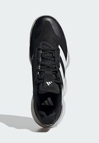 Black athletic shoe with a mesh upper, black laces, and three white stripes on the side. Features a padded collar and textured toe cap.