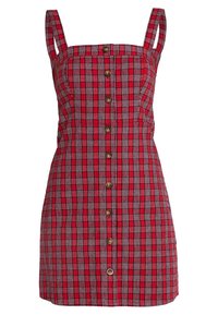 Abito a quadri rossi con scollatura quadrata, spalline sottili, chiusura frontale con bottoni e una silhouette aderente. Realizzato in tessuto testurizzato.