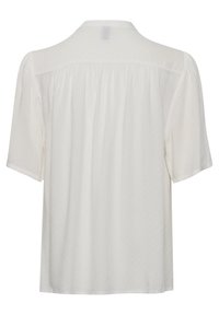 White short-sleeve blouse featuring a back yoke with pleats, a soft, sheer texture, and a relaxed fit. No distinct patterns or accents.