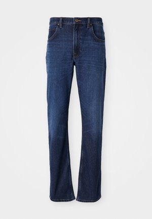 Σκούρα μπλε τζιν παντελόνι με ίσια γραμμή, πέντε τσέπες και ορατές ραφές. Το ύφασμα έχει λεία υφή και ελαφριά φθορά.