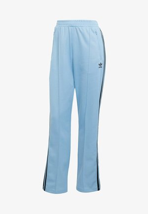 Pantaloni sportivi azzurri con strisce laterali nere, vita elasticizzata e tasche con cerniera. Realizzati in tessuto morbido e liscio.