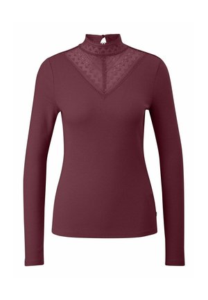 Maglietta a maniche lunghe con collo alto in tessuto a coste burghy. Presenta un pannello in pizzo trasparente con motivo geometrico sul collo e un'apertura a chiave sul retro.