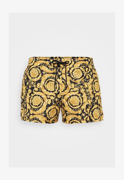 Mustad mustad ujumispüksid kullase lille- ja keerdlehtede mustriga, elastne vöökoht koos nööriühendusega ning sileda kangateksuurusega.