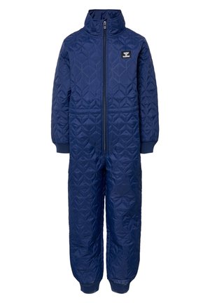 Combinaison matelassée bleu marine avec un col haut, une fermeture éclair sur toute la longueur et des poignets côtelés. Présente un motif hexagonal et une étiquette de marque sur la poitrine.