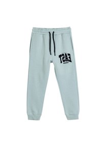 Pantalones jogger de color azul claro en material suave, con cintura elástica y cordón de ajuste, bolsillos laterales y un estampado gráfico negro en la pierna.