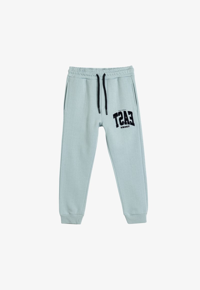 Lichtblauwe joggers van zacht materiaal, voorzien van een elastische tailleband met een trekkoord, zijzakken en een zwarte grafische print op het been.