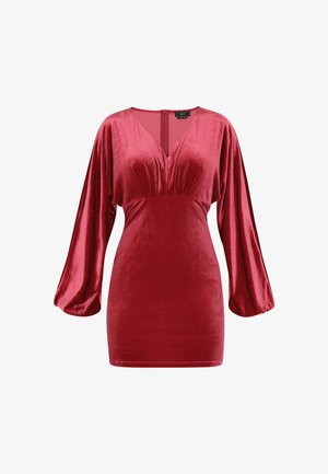 Vestido de terciopelo rojo con escote en V, cuerpo fruncido y mangas largas abullonadas. Cuenta con una cremallera en la parte central de la espalda y una textura suave.