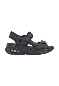 Sandale noire avec un imprimé léopard texturé, des sangles ajustables en Velcro, une semelle rembourrée et une caractéristique de coussin d'air visible.