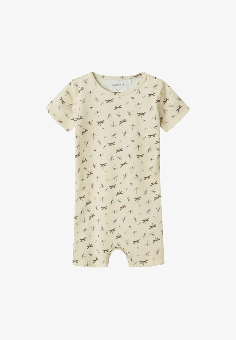 Combinaison à manches courtes en coton beige clair avec un motif de libellules en violet et bleu. Dotée d'un col rond et d'ouvertures pour les jambes.