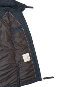 Navy quilted jacket interior with smooth lining, a zip pocket, and care label, featuring a contrasting edge trim and branded pull tab.