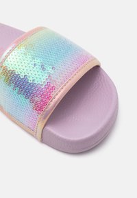 Slide sandal with a shiny iridescent sequined strap and a lavender sole, featuring a textured finish and padded pink trim.