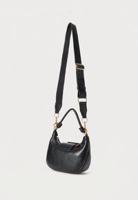Black leather shoulder bag with adjustable wide strap, gold hardware, zip closure, and a small flap pocket on the front.