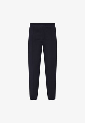 Marineblauwe tapered joggingbroek van een zachte stof met een brede elastische tailleband, voorzien van contrasterende stiksels en een voorzakdetails.