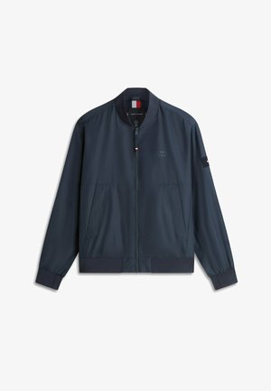Veste bombers bleu marine avec fermeture éclair à l'avant, poches latérales, col et poignets côtelés, et logo Tommy Hilfiger discret sur la poitrine et la manche.