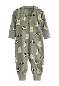 Grön tygdräkt med olika tecknade hunddesigns, långärmad, med blixtlås och elastiska ärmslut. Mjuk och andningsbar material.