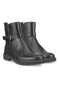 Bottines en cuir noir avec brides à boucle latérales, bouts arrondis, petits talons carrés et fermetures éclair sur le côté intérieur.