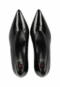 Black patent leather pointed-toe shoes with an open side, featuring a small red accent near the heel and a sleek, shiny finish.