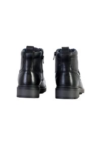 Botas negras de cuero hasta el tobillo con punta redonda, cierre de cremallera, laterales texturizados y suelas de goma planas, diseñadas para la durabilidad y la comodidad.