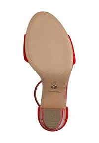 Red high-heeled sandal with a smooth sole, featuring a beige bottom and etched accents. Slip-on design with a slender heel and open toe.