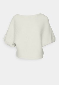 White cropped sweater with textured, ribbed fabric. Features short, wide sleeves and a boat neckline. Simple design without embellishments.