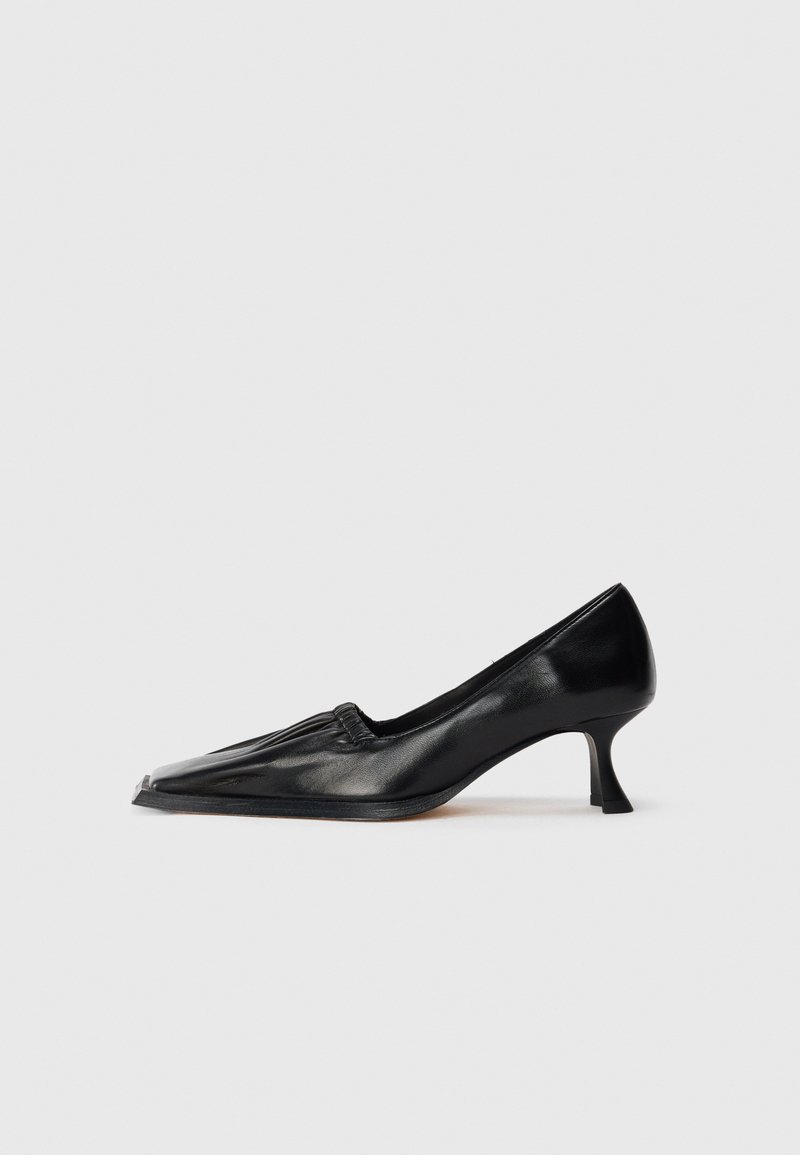 Black leather mid-heel shoe with square toe and slight ruched detail along the upper edge, shown in side profile on white background.