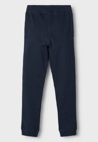Leggings en coton bleu marine avec une taille élastique, des jambes fuselées et des coutures renforcées à l'ourlet. Texture lisse sans embellissements.