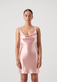 Satin pink mini dress with thin straps, cowl neck, and fitted silhouette. Smooth texture with subtle sheen, designed for a close fit.