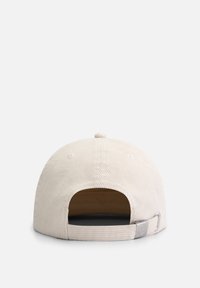 Light beige corduroy cap with a flat brim, an adjustable strap at the back, and ribbed texture. Features a small logo on the side.