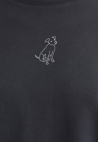 Black cotton t-shirt featuring a simple white outline of a sitting dog on the left chest. Smooth texture with a round neckline.