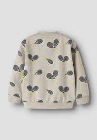 Hellbeiger Pullover mit einem wiederholenden Muster aus schwarzen Tennisschlägern und gelben Akzenten, mit gerippten Bündchen und Kragen für mehr Textur.