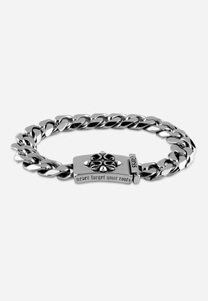 Silver metal chain bracelet featuring a segmented design, a decorative clasp with engraved text "never forget your roots," and polished finish.