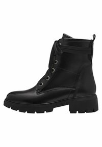 Bottines en cuir noir avec une semelle en caoutchouc épaisse, un laçage à l'avant et des œillets métalliques. Elles possèdent une languette à l'arrière et un dessus texturé.