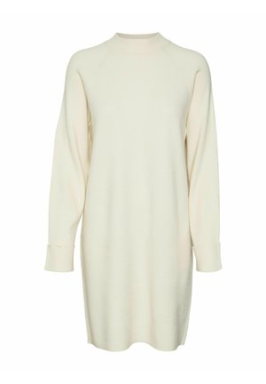 Licht crèmekleurige gebreide jurk met lange raglanmouwen, geribbelde textuur en een hoge hals. Kenmerkt zich door opgerolde mouwen en een ontspannen pasvorm.