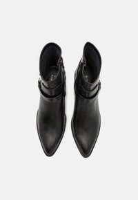 Black leather ankle boots with pointed toes, smooth texture, side zip closure, and ankle strap detail. Suitable for various occasions.