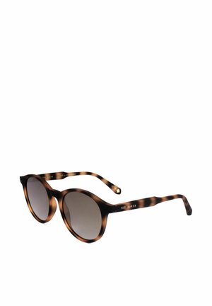 Occhiali da sole rotondi con montatura tartarugata, lenti scure e aste sottili con branding Ted Baker sul lato.