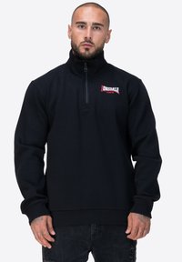 Felpa nera con zip e colletto alto. Presenta un logo Donsdale in rosso e un orlo e polsini a costine per un tocco di consistenza.