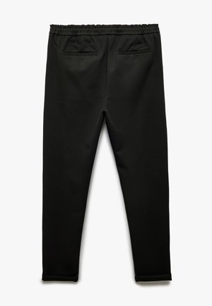 Black pants featuring an elastic waistband, two back pockets, slim fit, and cuffs at the ankle. Made from a smooth, stretchy fabric.