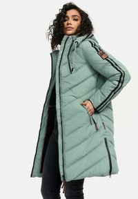 Manteau puffer teal clair avec capuchon, fermeture éclair à l'avant et deux poches latérales. Rayures noires verticales le long des manches et texture matelassée.